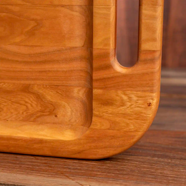 Cherry Barbecue Board with handles. Close  up of rounded corner of board.